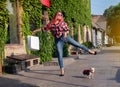 Fashionably dressed girl at the window of a boutique selling clothes. A woman holds a mini chihuahua in her arms. The pet is Royalty Free Stock Photo