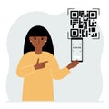 A woman holds a mobile phone in his hand with the text scan me and scans the qr code, which is located nearby.