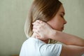 Woman holds neck with pain cervical muscle spasm by hand. Neck pain, cervical vertebrae, Disease of musculoskeletal