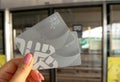 A woman holds NOL two metro cards while waiting for metro train in Dubai.