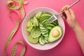 a woman holds a plate with a dietal avocado salad Royalty Free Stock Photo