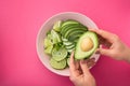 a woman holds a plate with a dietal avocado salad Royalty Free Stock Photo