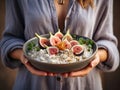 A woman holds a plate of rice porridge and fresh figs in her hands. Generated by AI