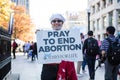 A Woman Holds a Pray to End Abortion Sign at a Stop the Steal Rally