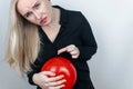 Conceptual photography. The woman holds a red ball near his belly, which symbolizes bloating and flatulence. Then she brings a nee