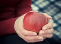 Woman holds ripe red apple in her hands. Fruit in female palms. Diet and healthy food concept Royalty Free Stock Photo