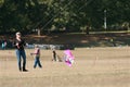 Woman Holds Ropes And Steers Kite At Autumn Festival