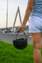 A woman holds a safety helmet after riding in an extreme park. The skate park, rollerdrome, quarter and half pipe ramps. Extreme