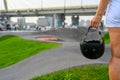 A woman holds a safety helmet after riding in an extreme park. The skate park, rollerdrome, quarter and half pipe ramps