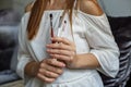 A woman holds several makeup brushes in her hands, a professional makeup artist