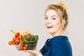 Woman holds shopping basket with vegetables Royalty Free Stock Photo
