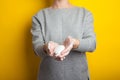 Woman holds and shows soap in her hands. Palms and fingers in soapy foam stretch the soap forward, on a yellow background. Hand Royalty Free Stock Photo