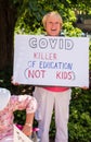 A Woman Holds a Sign Protesting School Closures due to COVID-19 Royalty Free Stock Photo