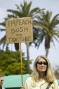 A woman holds a sign saying Impeach Bush for torture at an anti-Iraq War protest march in Santa Barbara, California on March 17