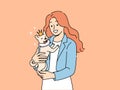 Woman holds small dog wearing crown in arms and smiles enjoying guardianship over puppy Royalty Free Stock Photo