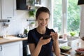 Woman holds smartphone search dietary healthy recipes on internet