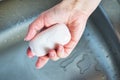 Woman holds soap in her hand over the sink. concept treating the skin of hands from viruses and microbes