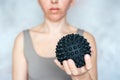 A woman holds a spiky trigger point massage ball used for muscle pain treatment and deep tissue massage Royalty Free Stock Photo