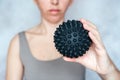 A woman holds a spiky trigger point massage ball used for muscle pain treatment and deep tissue massage Royalty Free Stock Photo