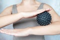 A woman holds a spiky trigger point massage ball used for muscle pain treatment and deep tissue massage Royalty Free Stock Photo