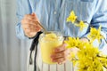 Woman holds spoon and jar of lemon curd Royalty Free Stock Photo