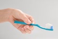 Woman holds toothbrush with toothpaste in her hand isolated on white background Royalty Free Stock Photo