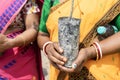 A woman holds a tree plant as she participated in ten million tree plantation drive during Amrit Brikhya Abhiyan in Guwahati, Ass