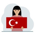 A woman holds a Turkish flag in his hands. Concept for demonstration, national holiday, Turkey day or patriotism