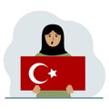 A woman holds a Turkish flag in his hands. Concept for demonstration, national holiday, Turkey day or patriotism