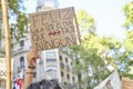 A woman holds up a cardboard with a message against violence against women