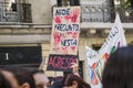 A woman holds up a poster with a message against violence against women