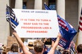 A Woman Holds a Sign Reading `Wake Up America` at a Conservative Rally