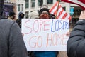 Woman Holds up a Sign `Sore Losers Go Home` at an Armed Demonstration at the Ohio Statehouse Ahead of Biden`s Inauguration Royalty Free Stock Photo