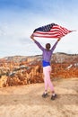 Woman holds US flag, Bryce Canyon National Park Royalty Free Stock Photo