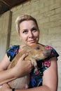 A woman holds a wild boar piglet in her hands. Close-up Royalty Free Stock Photo