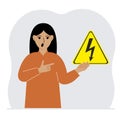 A woman holds a yellow triangular warning sign with a black lightning in his hand. The concept of the danger of electric Royalty Free Stock Photo