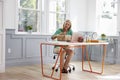 Woman At Home Addressing Package For Mailing