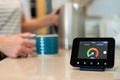 Woman At Home Boiling Kettle For Hot Drink With Smart Energy Meter In Foreground Royalty Free Stock Photo