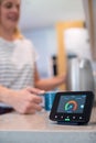 Woman At Home Boiling Kettle For Hot Drink With Smart Energy Meter In Foreground Royalty Free Stock Photo