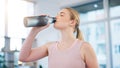 Woman, home and drink of water for sports break, energy and workout performance. Thirsty athlete, bottle and nutrition Royalty Free Stock Photo