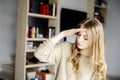 Woman in a home garden touching her head with her hands Royalty Free Stock Photo