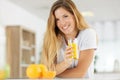 Woman at home holding glass orange juice