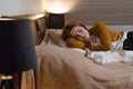 Woman at home holding her cat, room interior on the bed Royalty Free Stock Photo