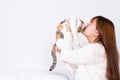 Woman at home holding and kissing her lovely fluffy cat. Multicolor tabby cute kitten. Pets and lifestyle concept Royalty Free Stock Photo