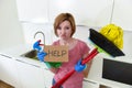 Woman at home kitchen in gloves with cleaning broom and mop asking for help