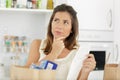 woman at home looking over shopping receipt