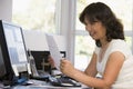 Woman in home office with computer and paperwork Royalty Free Stock Photo