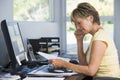 Woman in home office with computer and paperwork Royalty Free Stock Photo