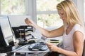 Woman in home office with computer and paperwork Royalty Free Stock Photo