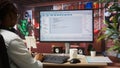 Woman in home office looking at UI on PC screen, typing code Royalty Free Stock Photo